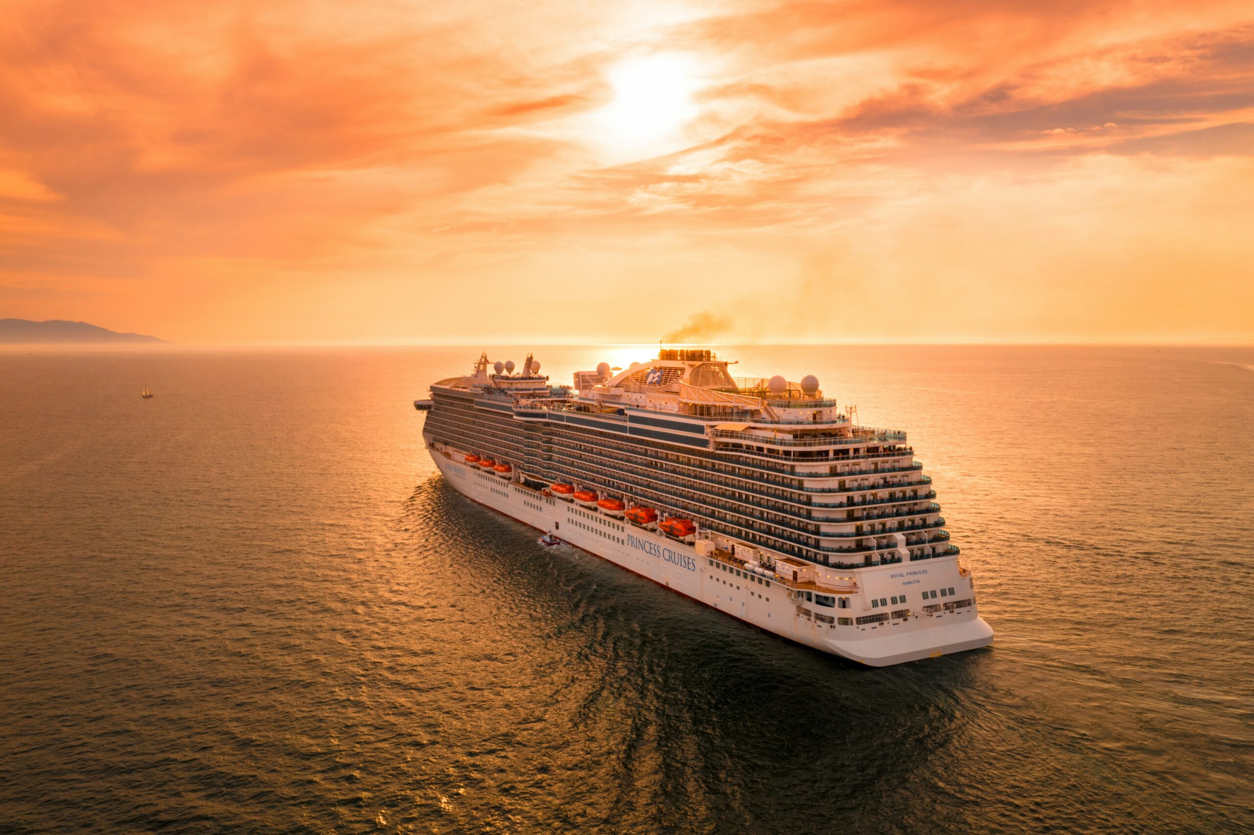 A cruise ship sailing at sunset